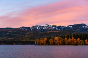 a view of a lake with mountains in the background at Larch House in Whitefish