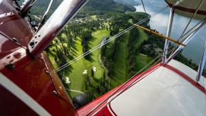 an aerial view of a golf course from a helicopter at Larch House in Whitefish +10 photos