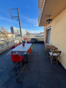 a patio with tables and chairs on a building at Le Toit des Volcans - 8 couchages - Terrasse privée et Wifi in Clermont-Ferrand