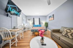 a living room with a couch and a table at Sea Steps By Lowkl in Pompano Beach