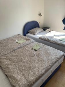 two beds sitting next to each other in a room at Apartmani Stolac in Stolac
