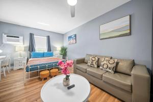 a living room with a couch and a table at Sea Steps By Lowkl in Pompano Beach +48 photos