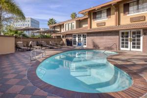 a swimming pool in front of a building at SureStay Plus Hotel by Best Western Mountain View in Mountain View
