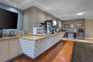 a bar in a hotel room with a flat screen tv at SureStay Plus Hotel by Best Western Mountain View in Mountain View