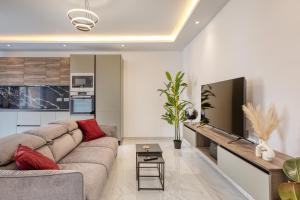 a living room with a couch and a tv at The Bellview Suite - Luxury 1 BR APT - Central Gzira in Il-Gżira