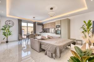 a living room with a bed and a kitchen at The Bellview Suite - Luxury 1 BR APT - Central Gzira in Il-Gżira
