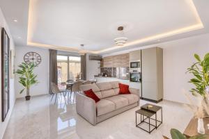 a living room with a couch and a kitchen at The Bellview Suite - Luxury 1 BR APT - Central Gzira in Il-Gżira +17 photos