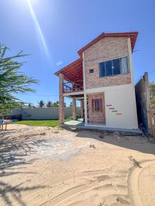 a house with a garage in front of it at Lumoa Beach Chalé Tutoia in Tutóia
