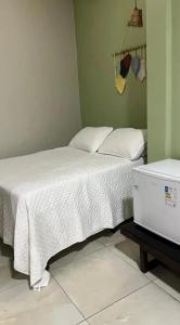 a bedroom with a bed with a white comforter at Lumoa Beach Chalé Tutoia in Tutóia