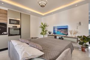 a bedroom with a bed and a television in it at The Bellview Suite - Luxury 1 BR APT - Central Gzira in Il-Gżira