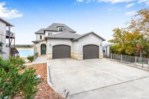 a white house with two garage doors at Lakeside Dreamhouse in Canyon Lake