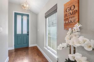 a hallway with a blue door and a window at Lakeside Dreamhouse in Canyon Lake