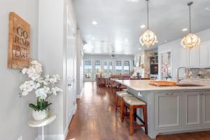 a kitchen with white cabinets and a large island at Lakeside Dreamhouse in Canyon Lake