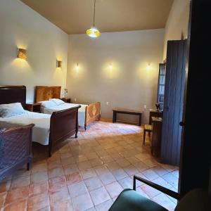 a living room with two beds and a room with at La Casa de Ticho in Mascota