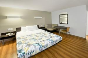 a bedroom with a bed and a table and a desk at The Reserve Inn in Salisbury