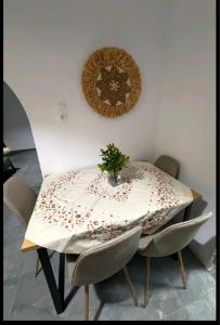 a table with a white table cloth with a plant on it at Jimmy's Crib in Moúdhros