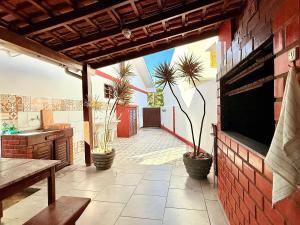 a kitchen with potted plants and a table on a patio at Residencial da Villa in Imbituba