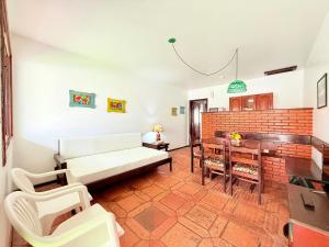 a living room with a couch and a table at Residencial da Villa in Imbituba