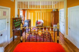 a bedroom with a bed with a red rug at Chinoiserie in Katoomba