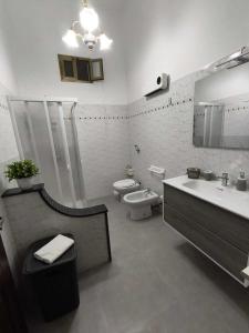 a bathroom with a sink and a toilet and a mirror at Casa Sciacca: La Tua Casa Vacanze Ideale a Marsala in Marsala +9 photos