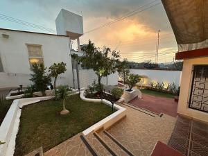 a house with a garden with trees in it at Casa Brasa, Sol & Jardín in Guanajuato
