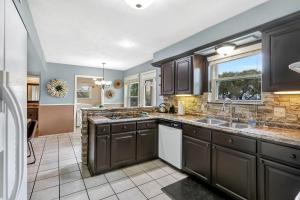 a kitchen with dark brown cabinets and a window at Lakeside Overlook in Canyon Lake
