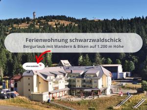 a picture of a building with a mountain in the background at FeWo Schwarzwaldschick Feldberg I Bergurlaub I Balkon I Whirlwanne I Tiefgarage I HochschwarzwaldCard inkl in Feldberg
