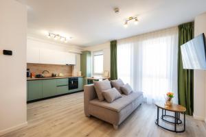 a living room with a couch and a table at NXN Airportstay in Cluj-Napoca