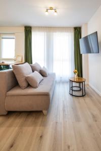 a living room with a couch and a table at NXN Airportstay in Cluj-Napoca