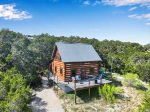 a cabin in the woods with a deck at Ozuye Lodge in Fischer +20 photos
