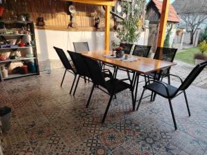 a wooden table and chairs on a patio at Apartman Katarina Bački Monoštor in Bački Monoštor