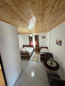 a living room with a couch and a table at Xhoen guesthouse in Shkodër