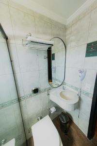 a bathroom with a sink and a mirror and a toilet at Zagat Classic Hotel in Foz do Iguaçu +24 photos
