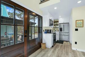 a kitchen with white appliances and a wooden door at Lakeview A-Frame in Canyon Lake