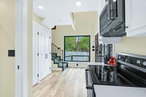 a kitchen with white cabinets and a large window at Lakeview A-Frame in Canyon Lake