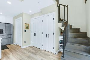 a kitchen with white cabinets and a staircase at Lakeview A-Frame in Canyon Lake