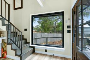 a staircase with a large window in a house at Lakeview A-Frame in Canyon Lake +37 photos