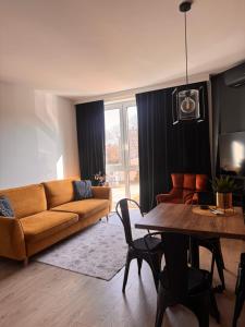 a living room with a couch and a table at Castle Apartments Malbork in Malbork