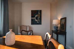 a dining room with a table with a vase on it at Drumornie in Brora