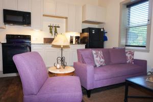 a living room with two purple chairs and a table at Lavender in Wimberley +10 photos