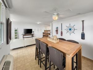 a dining room with a wooden table and chairs at Haudimar Beach Apt Ocean Front With Parking in San Antonio +34 photos
