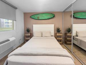 a bedroom with two beds and a window at Haudimar Beach Apt Ocean Front With Parking in San Antonio