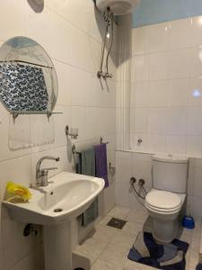 a white bathroom with a toilet and a sink at Scorpion House Luxor in Luxor +289 photos