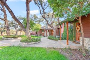 a house with a walkway in front of a yard at Lawlis Lodge in Wimberley