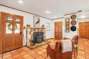 a living room with a fireplace and a door at Lawlis Lodge in Wimberley