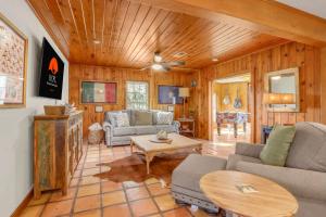 a living room with a couch and a table at Lawlis Lodge in Wimberley +35 photos