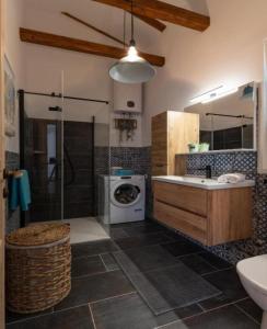 a bathroom with a sink and a washing machine at Apartment Zdravko near centar in Novalja