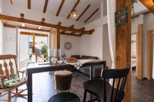 a living room with a dining room table and chairs at Apartment Zdravko near centar in Novalja