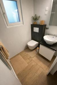 a bathroom with a toilet and a sink and a window at Summer Stay - Mobile Home in Biograd na Moru +35 photos