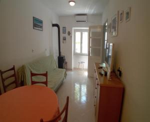a living room with a couch and a table at House Veli Iz oldtown in Veli Iž